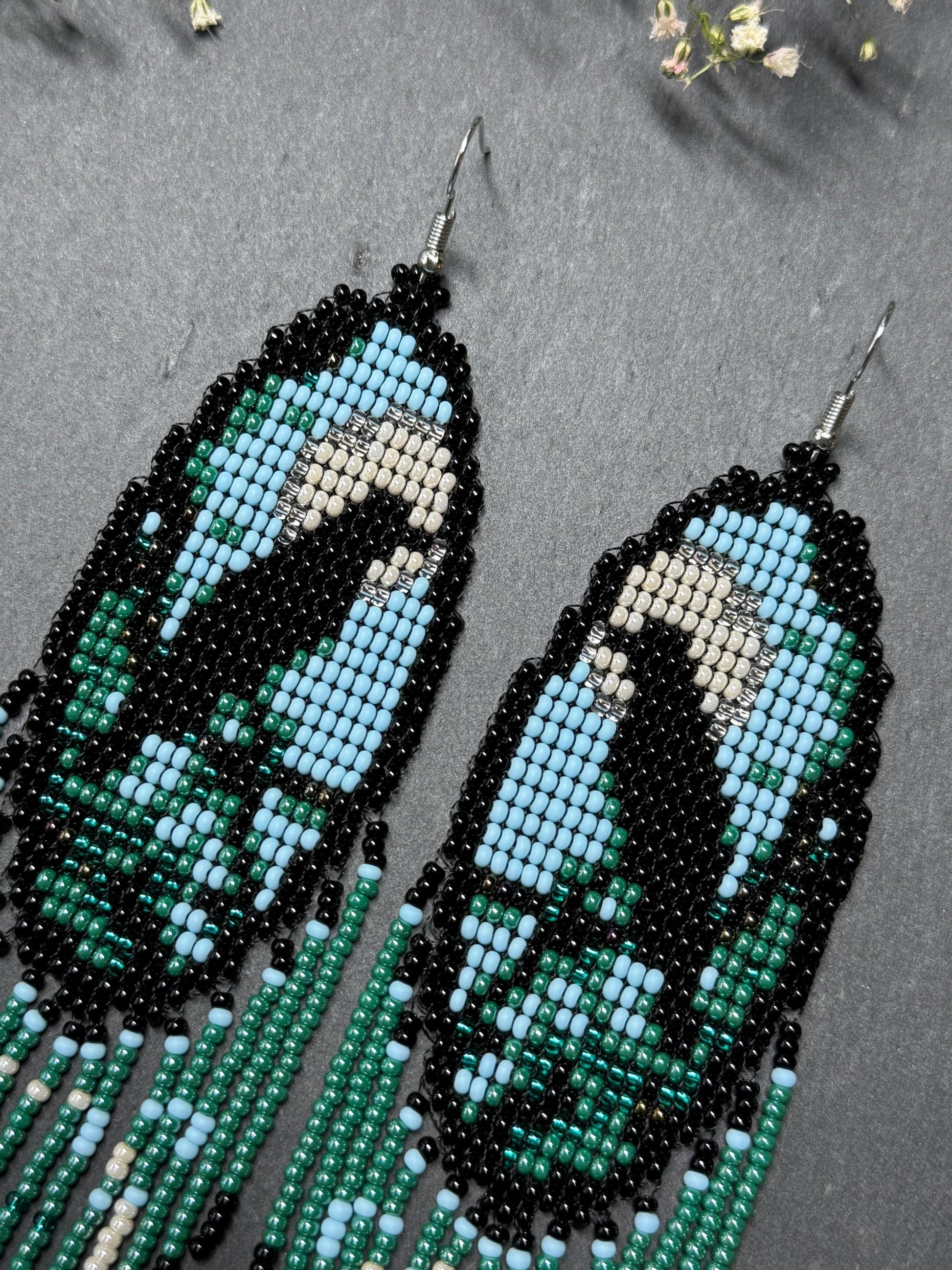 Long handmade beaded earrings in black, green, blue and beige featuring a raven and moon design with fringe. Boho statement jewelry, unique gift for her image 4