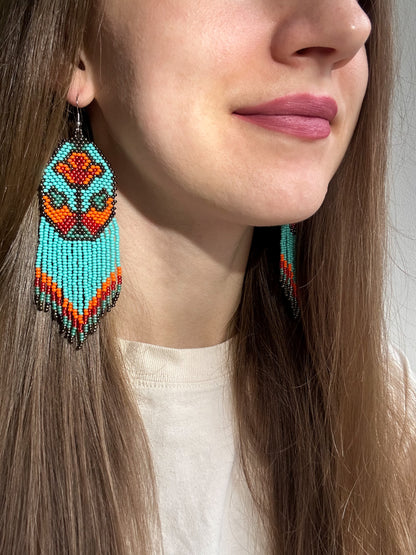 Unique handmade long beaded earrings in turquoise, orange, and red with floral design and fringe. Boho statement jewelry, cute multicolor earrings for women image 2
