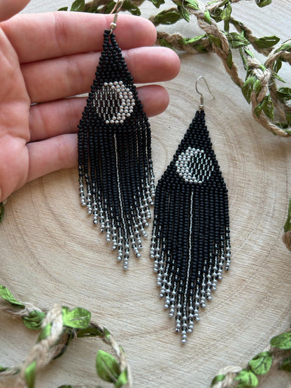 Unique handmade black beaded earrings with silver lunar eclipse motif and fringe. Boho celestial statement jewelry for mystical and artistic style image 6