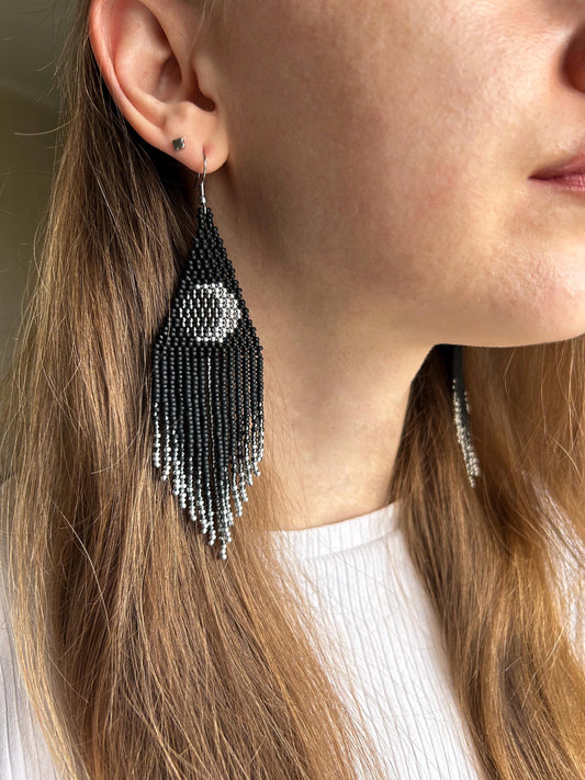 Unique handmade black beaded earrings with silver lunar eclipse motif and fringe. Boho celestial statement jewelry for mystical and artistic style image 2