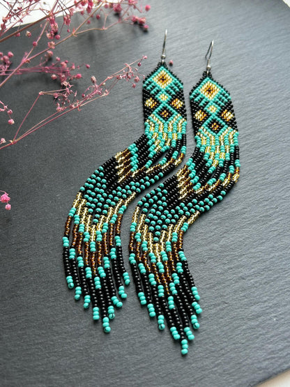 Handmade long black, turquoise, and gold beaded earrings with Native American ethnic design and fringe. Unique boho statement earrings for women image 4