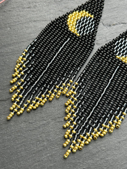 Handmade long black beaded earrings with golden lunar eclipse design and boho fringe. Unique statement jewelry image 4