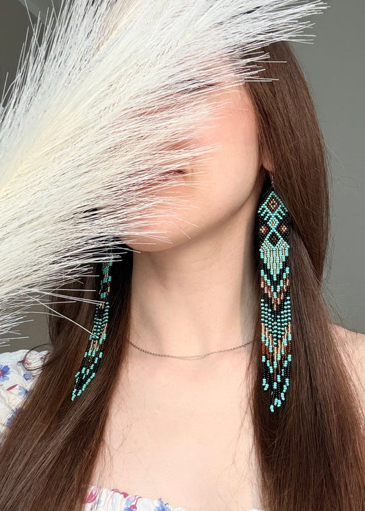 Handmade long black, turquoise, and gold beaded earrings with Native American ethnic design and fringe. Unique boho statement earrings for women image 2
