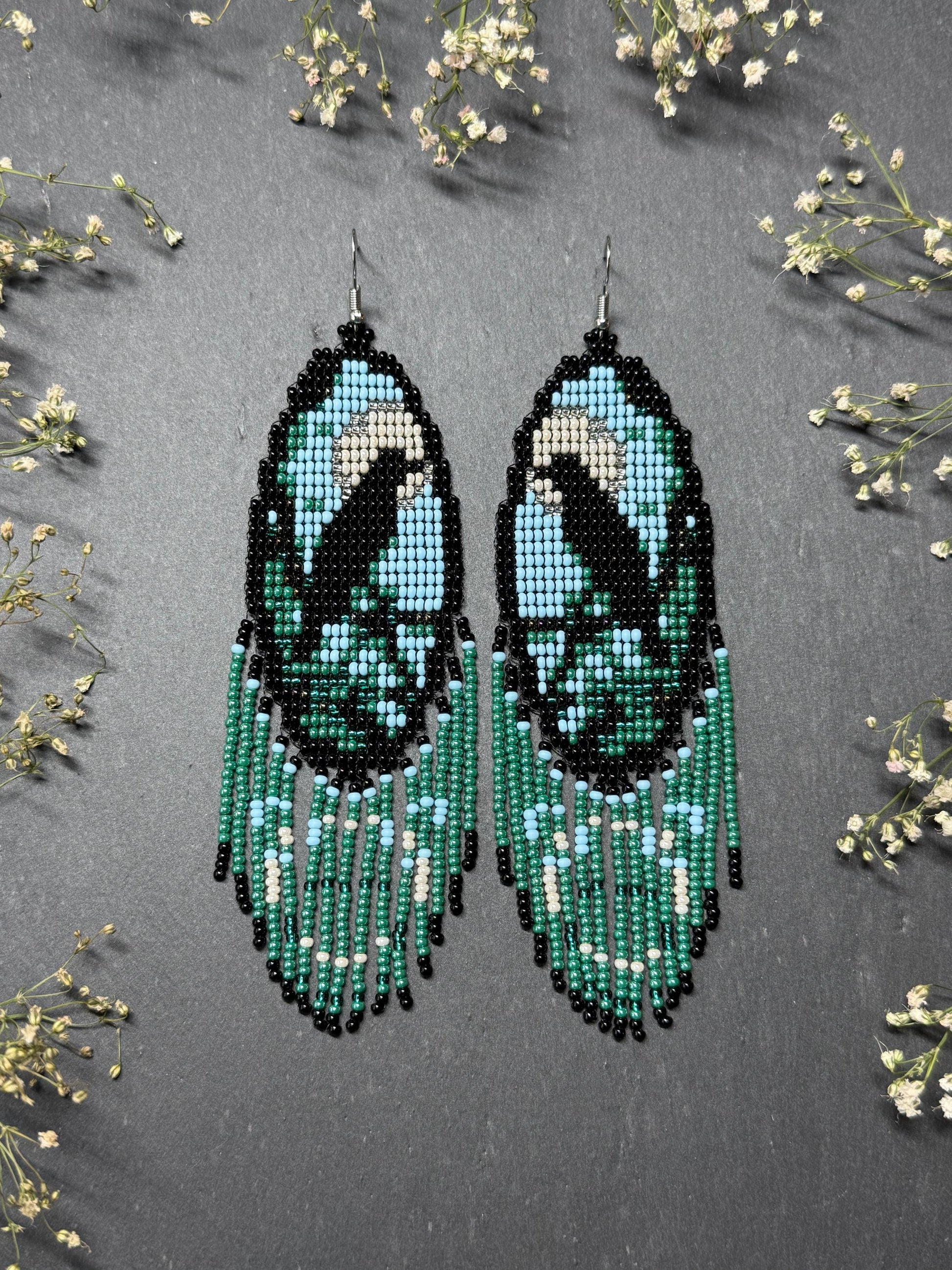 Long handmade beaded earrings in black, green, blue and beige featuring a raven and moon design with fringe. Boho statement jewelry, unique gift for her image 1