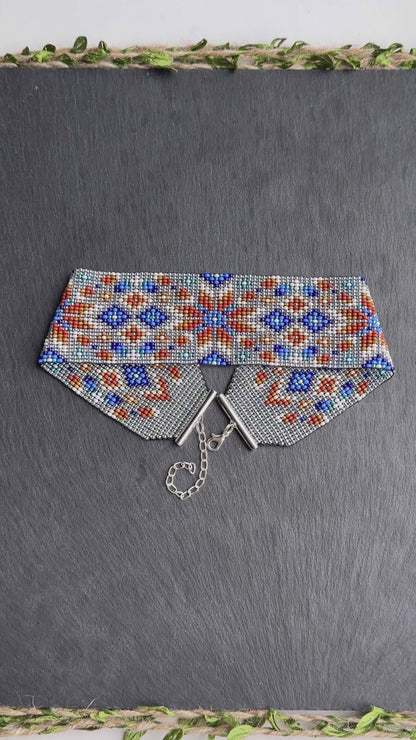 Unique handmade beaded choker with brown star ornament and blue accents on transparent base. Unique boho statement choker necklace for standout style video 1
