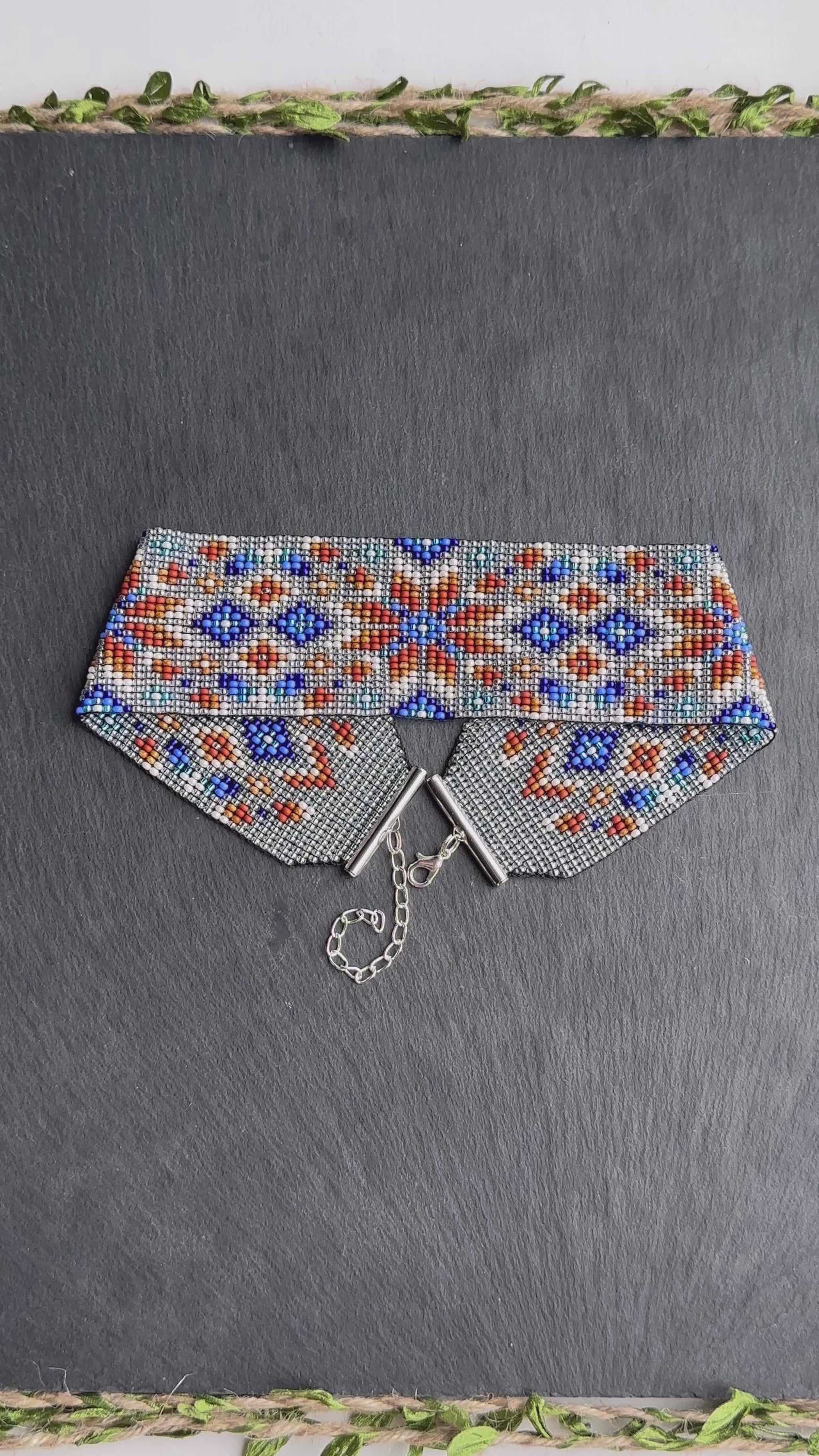 Unique handmade beaded choker with brown star ornament and blue accents on transparent base. Unique boho statement choker necklace for standout style video 1
