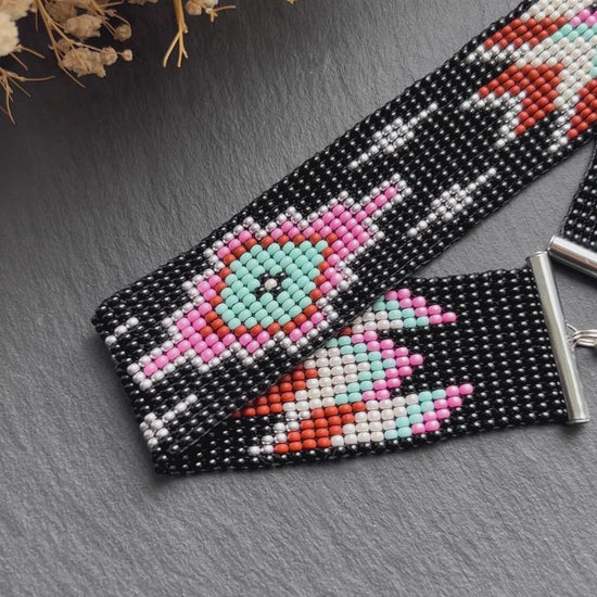 Unique handmade black beaded choker with geometric ornament in turquoise, pink, beige, and silver tones. Native American style boho statement choker necklace with adjustable chain video 1