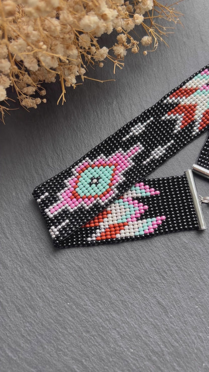 Unique handmade black beaded choker with geometric ornament in turquoise, pink, beige, and silver tones. Native American style boho statement choker necklace with adjustable chain video 1