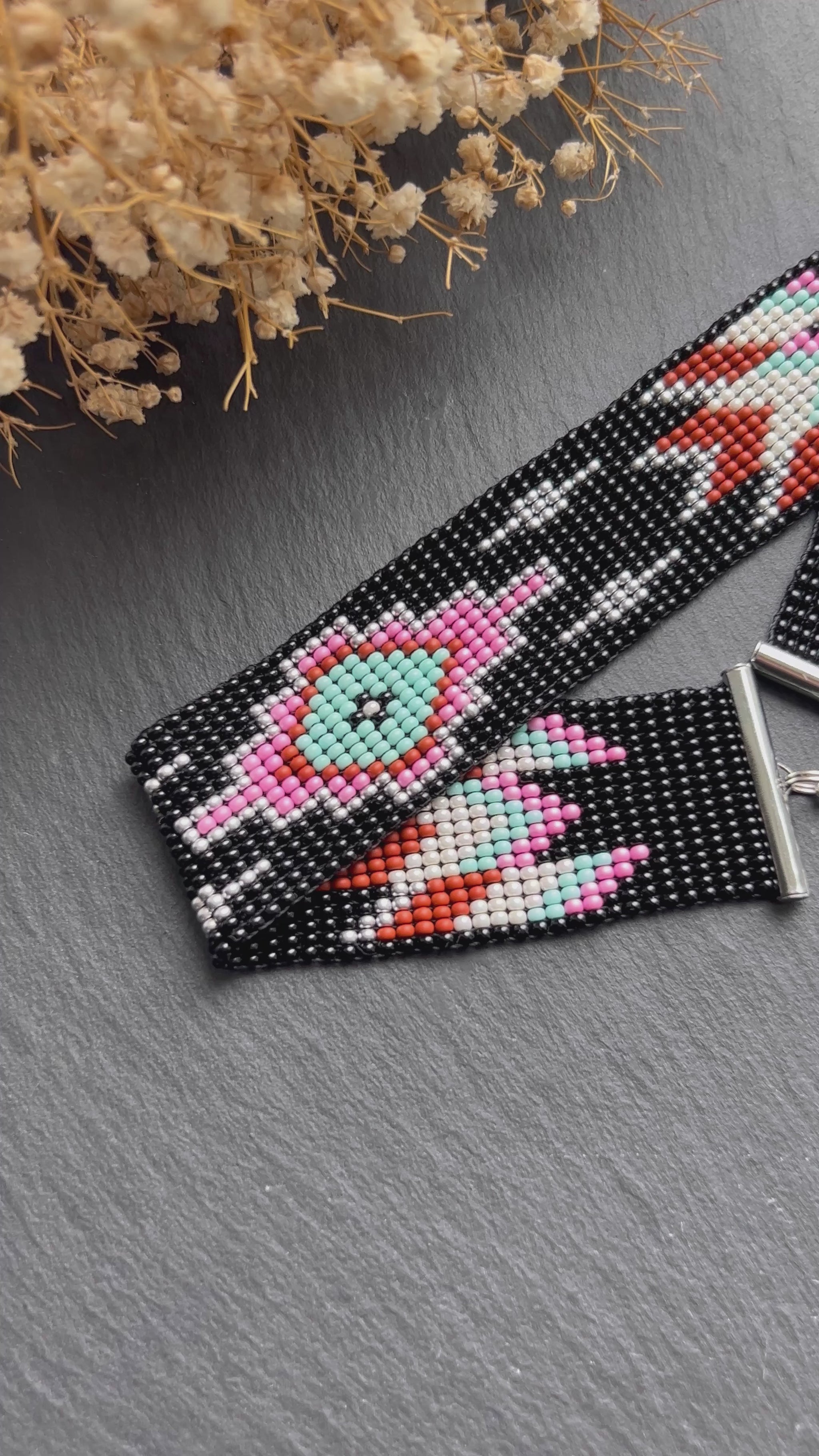 Unique handmade black beaded choker with geometric ornament in turquoise, pink, beige, and silver tones. Native American style boho statement choker necklace with adjustable chain video 1
