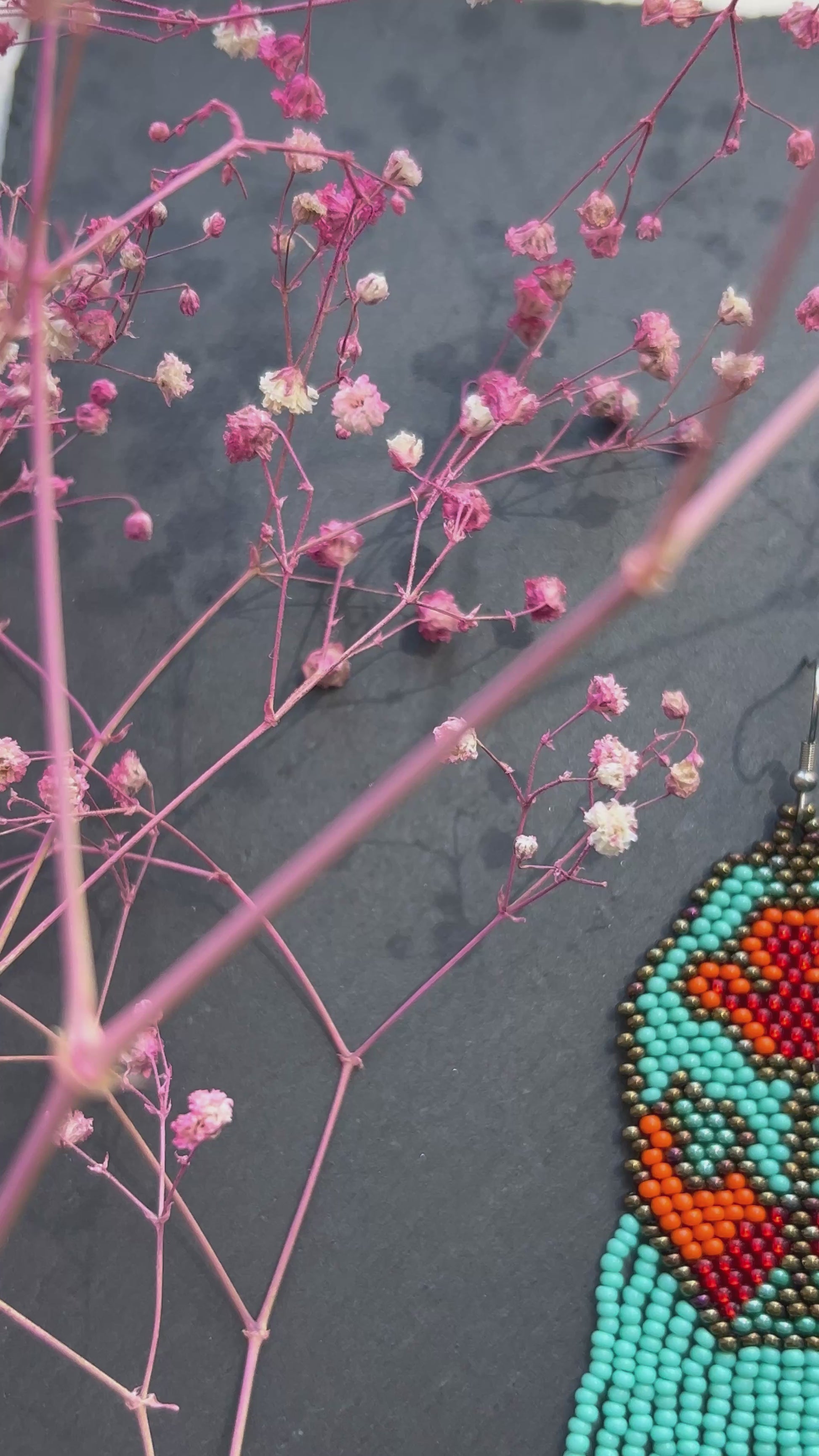 Unique handmade long beaded earrings in turquoise, orange, and red with floral design and fringe. Boho statement jewelry, cute multicolor earrings for women video 1