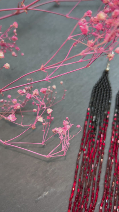 Long handmade black and red ombre beaded earrings with flowing fringe. Boho statement jewelry, unique artisanal accessory for bold everyday or evening style video 1