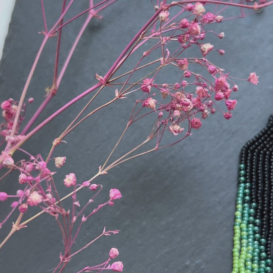 Long ombre beaded earrings in black and green with delicate fringe. Unique handmade jewelry for women, combining modern style with effortless elegance video 1