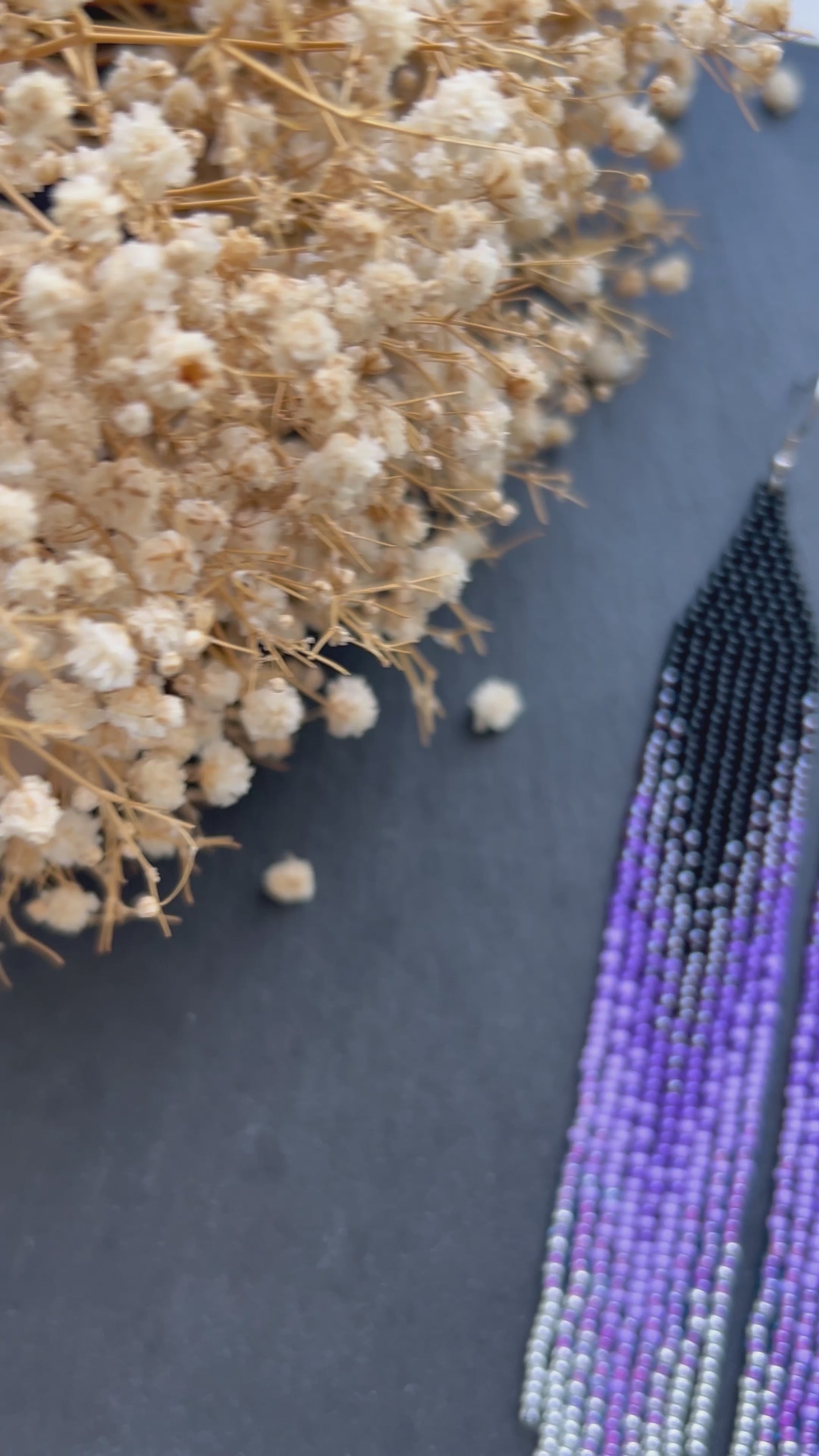 Long black beaded earrings in purple ombré style with fringe and silver tips. Handmade boho jewelry that is unique, vibrant, and adds elegance and movement  video 1