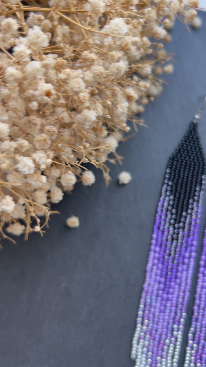 Long black beaded earrings in purple ombré style with fringe and silver tips. Handmade boho jewelry that is unique, vibrant, and adds elegance and movement  video 1