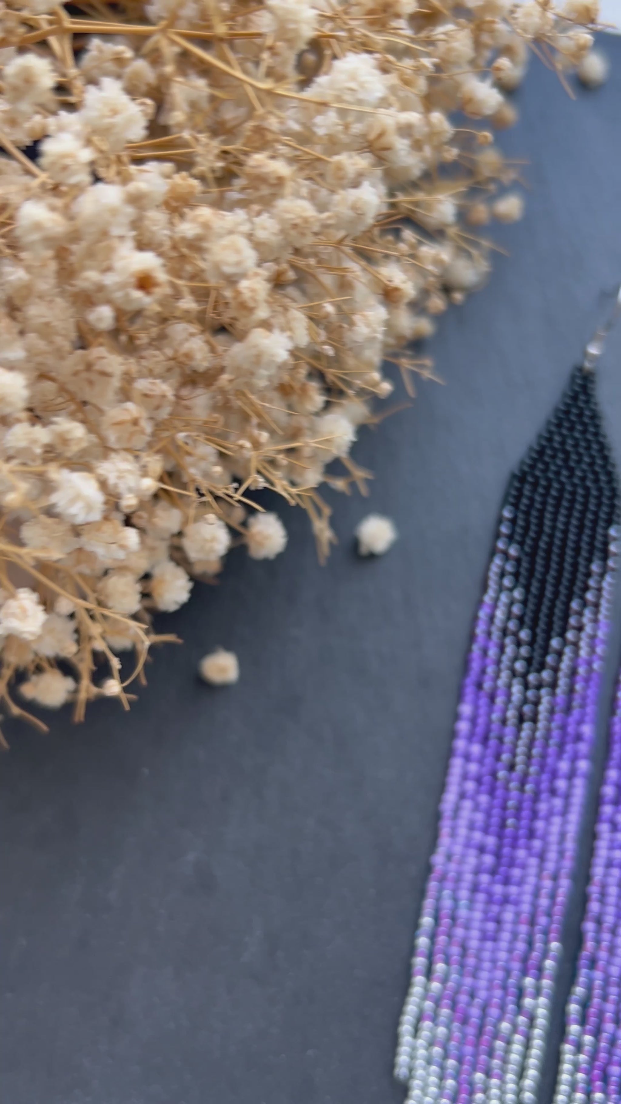 Long black beaded earrings in purple ombré style with fringe and silver tips. Handmade boho jewelry that is unique, vibrant, and adds elegance and movement  video 1