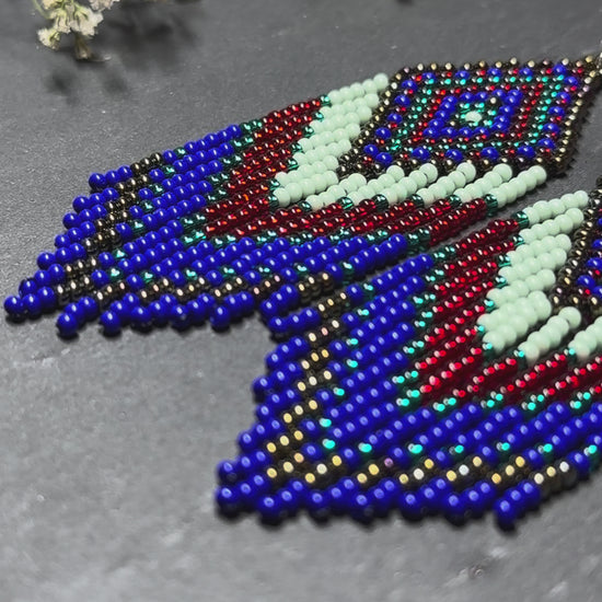 Handmade Blue, green and red beaded fringe earrings with geometric style. Unique bright boho statement jewelry with Native-inspired design and artisan beadwork video 1