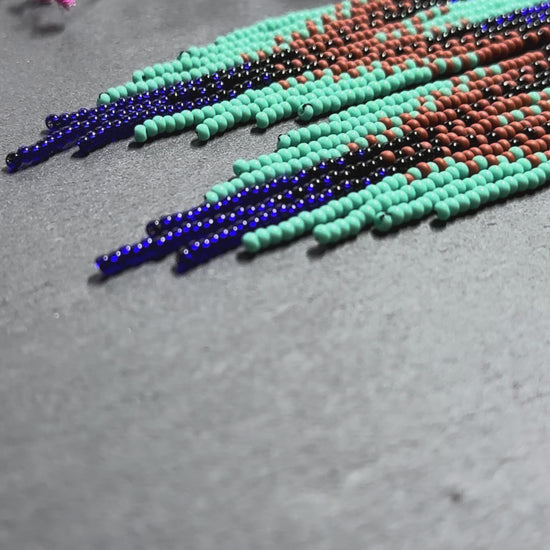 Bright blue, black, brown, and turquoise handmade beaded fringe earrings for women. Unique boho jewelry and statement beadwork, perfect native gift for women video 1