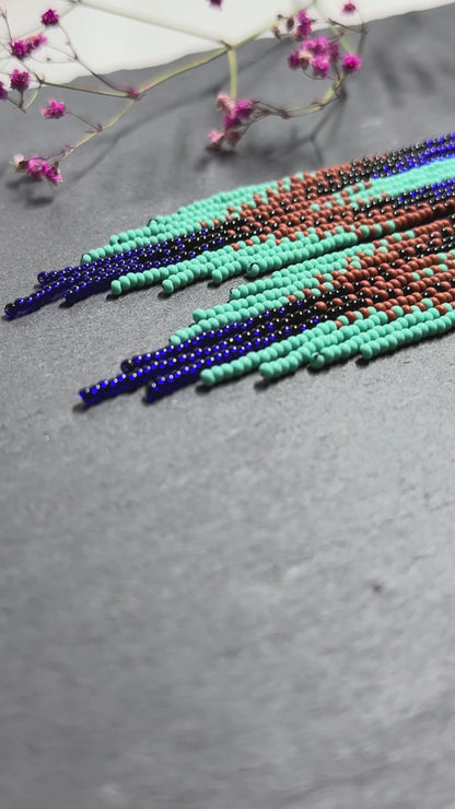 Bright blue, black, brown, and turquoise handmade beaded fringe earrings for women. Unique boho jewelry and statement beadwork, perfect native gift for women video 1