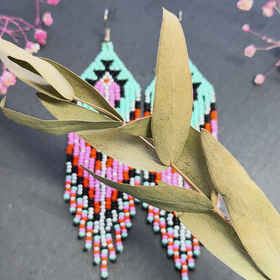 Handmade long beaded boho earrings in turquoise, black, silver, pink, and orange. Geometric design with elegant fringe, lightweight statement jewelry for any occasion  video 1