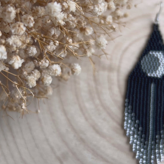 Unique handmade black beaded earrings with silver lunar eclipse motif and fringe. Boho celestial statement jewelry for mystical and artistic style video 1
