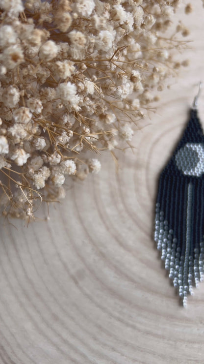 Unique handmade black beaded earrings with silver lunar eclipse motif and fringe. Boho celestial statement jewelry for mystical and artistic style video 1