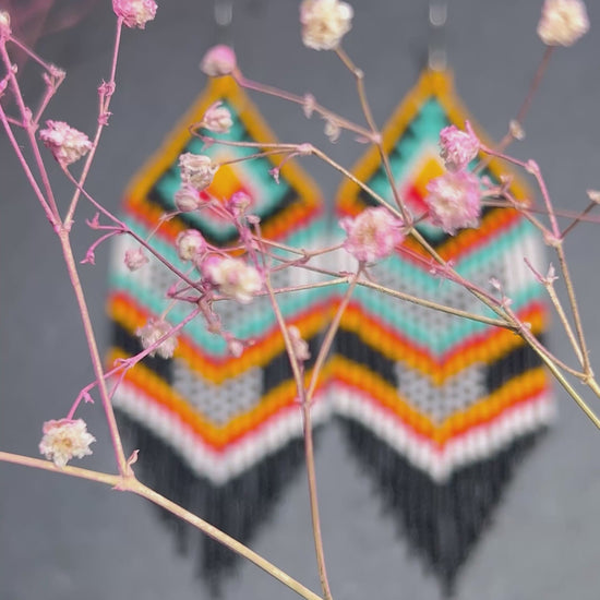 Bright handmade beaded fringe earrings in black, white, turquoise, red and orange with Native American motif. Statement boho earrings for women, perfect gift video 1