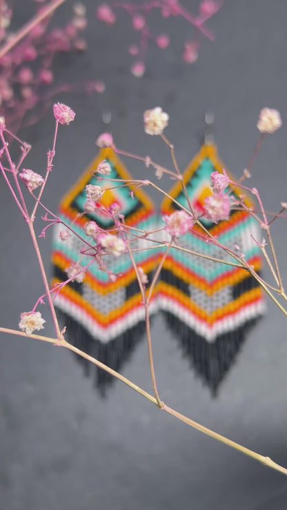 Bright handmade beaded fringe earrings in black, white, turquoise, red and orange with Native American motif. Statement boho earrings for women, perfect gift video 1