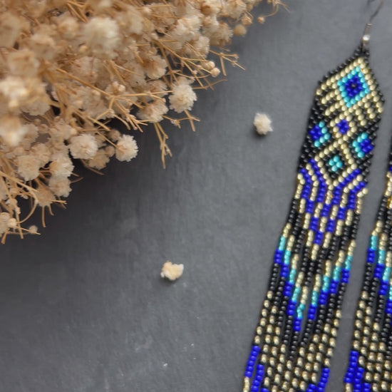 Handmade long black, blue, and gold beaded earrings with Native American ethnic design and fringe. Unique statement boho earrings for women video 1