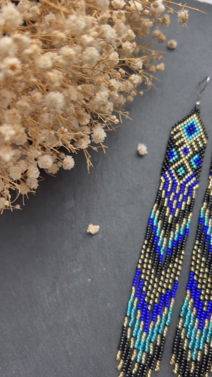 Handmade long black, blue, and gold beaded earrings with Native American ethnic design and fringe. Unique statement boho earrings for women video 1
